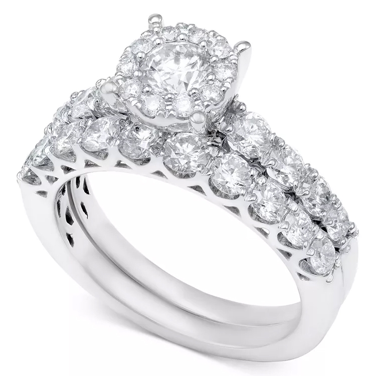 A bridal set featuring a white gold band with a 2-carat total weight of diamonds, showcasing a round solitaire with a halo and a matching diamond-studded wedding band.