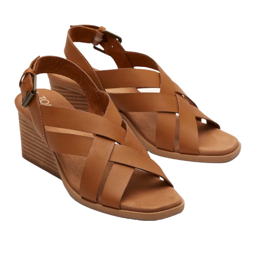 A pair of brown wedge sandals with crisscross straps and ankle buckles, featuring a cushioned footbed and stacked heel design.