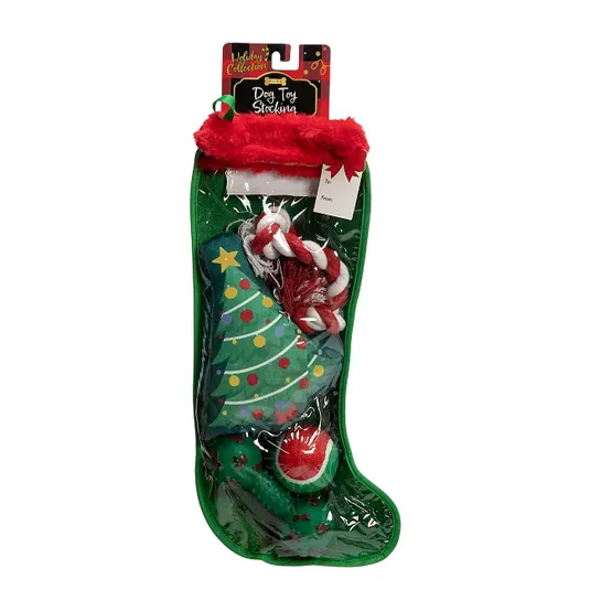 Christmas-themed dog toy stocking containing a green Christmas tree plush, a red and white rope toy, and a red ball.