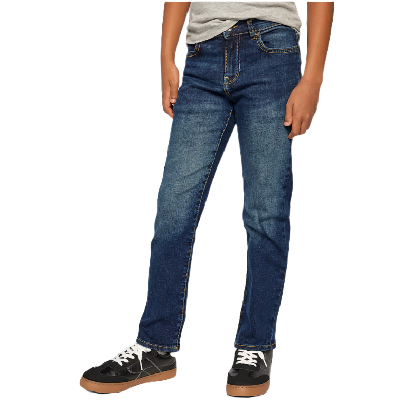 A person wearing medium-wash blue jeans and black sneakers with white laces, paired with a gray shirt.