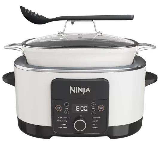 Ninja slow cooker and multi-cooker with a control panel featuring modes for slow cook, sear/sauté, steam, keep warm, sous vide, braise, bake, and proof. Includes a glass lid and a slotted spoon.
