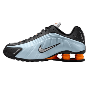 A Nike Shox TL sneaker with a black and light blue upper, featuring the signature Swoosh and orange Shox cushioning.