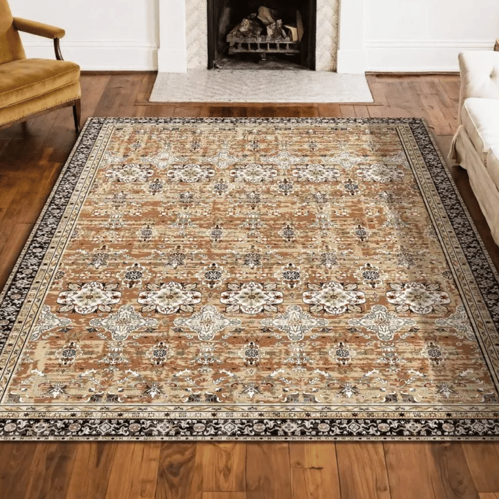 A patterned area rug with intricate floral and geometric designs, featuring a brown, beige, and black color scheme, placed on a wooden floor near a fireplace.