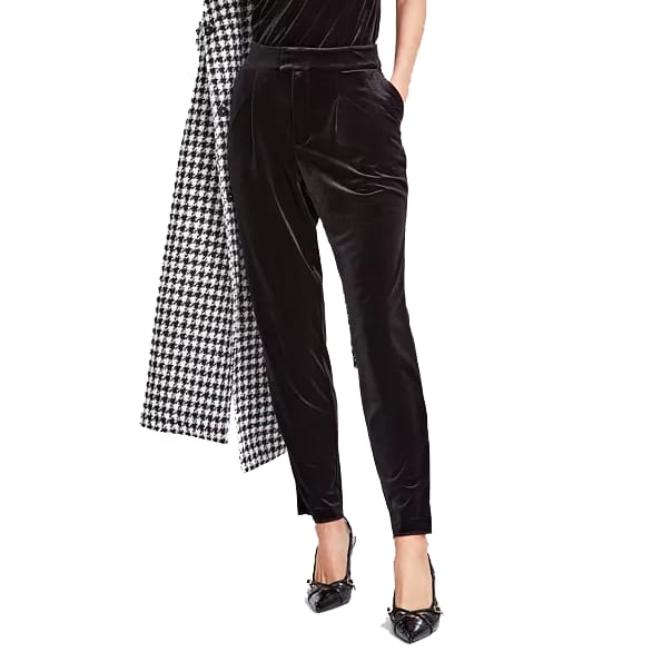 Black velvet pants with a high waist and a tailored, tapered fit. They feature side pockets and are paired with black pointed shoes and a houndstooth-patterned scarf draped to the side.
