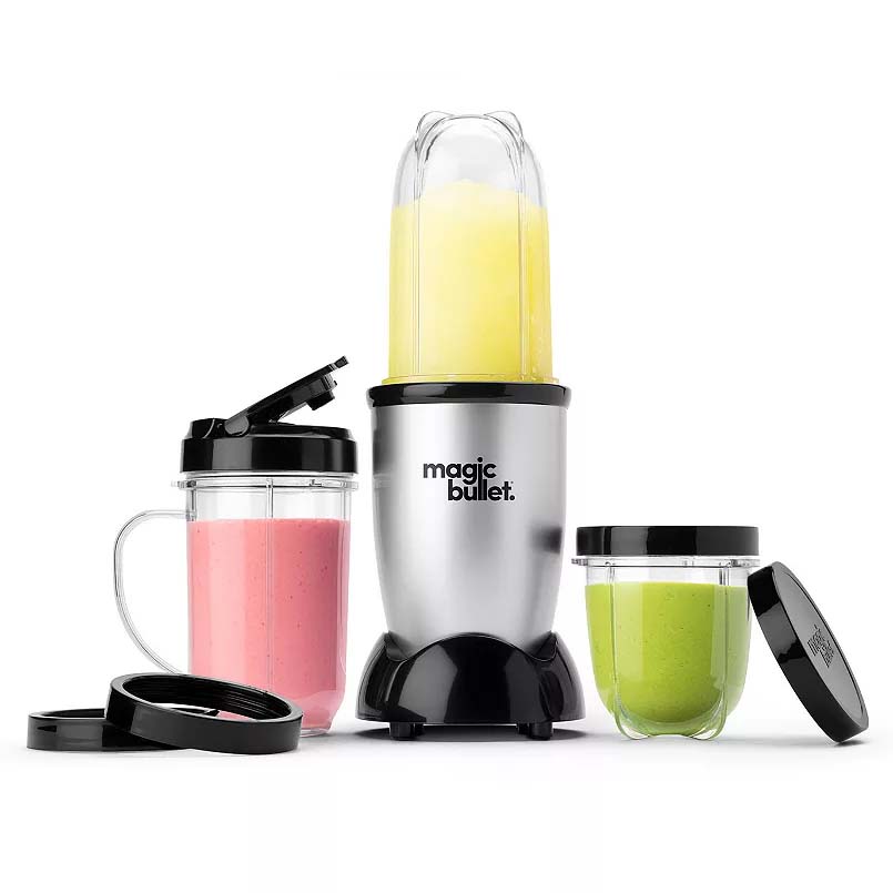 Magic Bullet blender set with three cups of various sizes, one blender base, and lids. Contains smoothies in pink, green, and yellow colors.