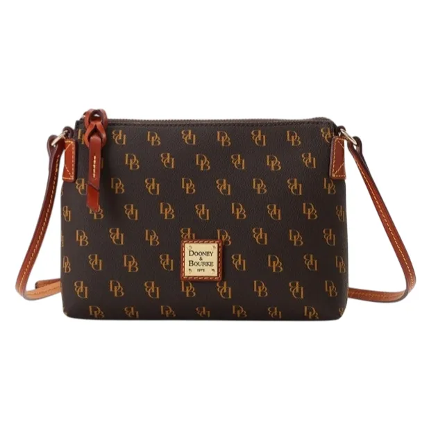 A Dooney & Bourke crossbody bag with a brown monogram pattern featuring \“DB\“ initials, a leather strap, and a logo patch on the front.