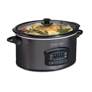 A black Hamilton Beach Slow Cooker with a digital display, showing \“HIGH\“ temperature setting, and a glass lid revealing food inside.