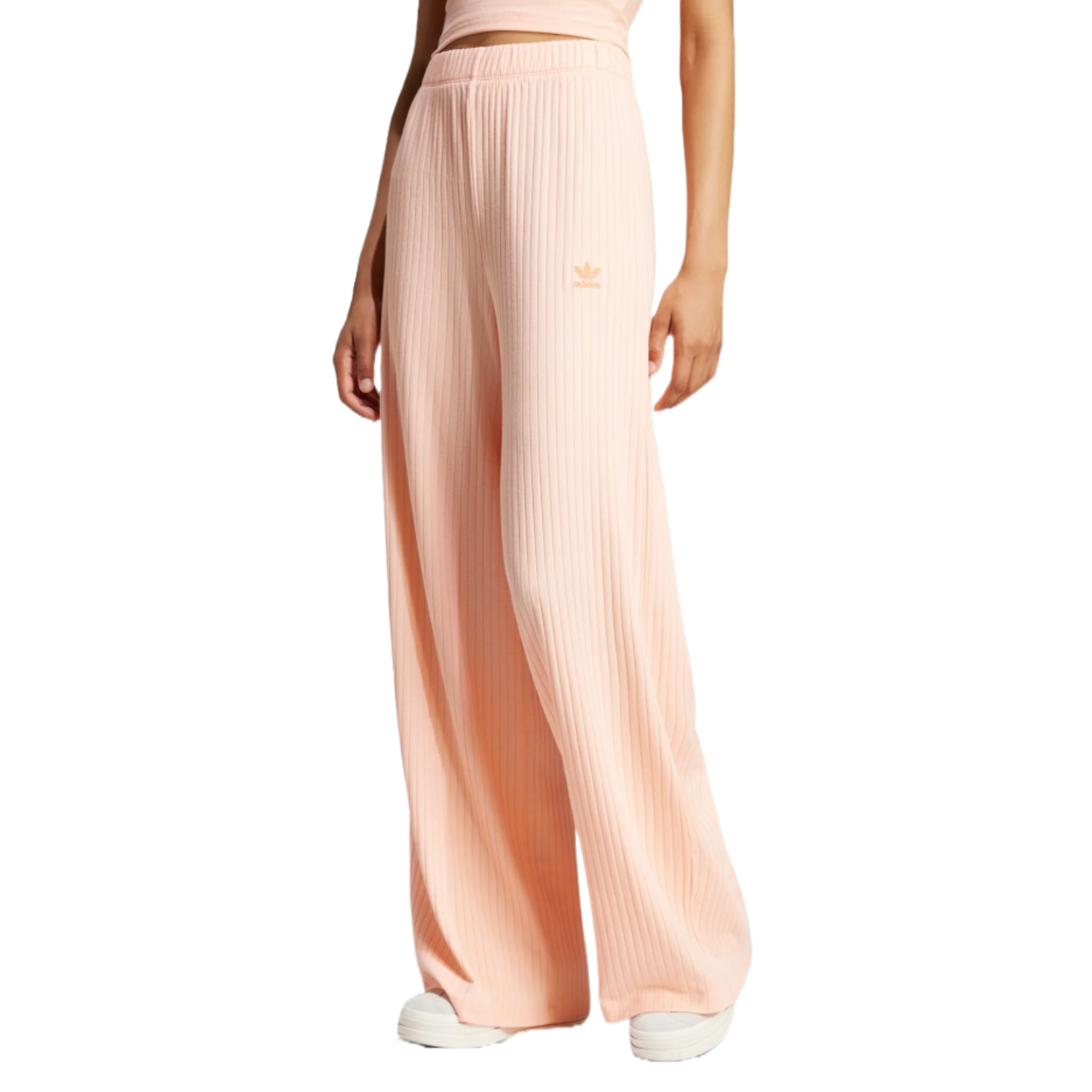 Peach-toned wide rib pants by Adidas featuring a relaxed fit, elastic waistband, and iconic logo on one side.