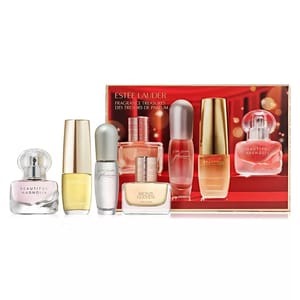 Estee Lauder Fragrance Treasures set includes Beautiful Magnolia, Beautiful, Pleasures, and Bronze Goddess perfumes, each in compact bottles. The set is displayed against a red backdrop.