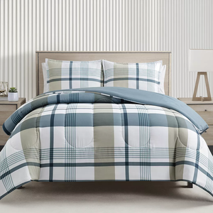 A bed with a blue and beige plaid comforter set including pillows.