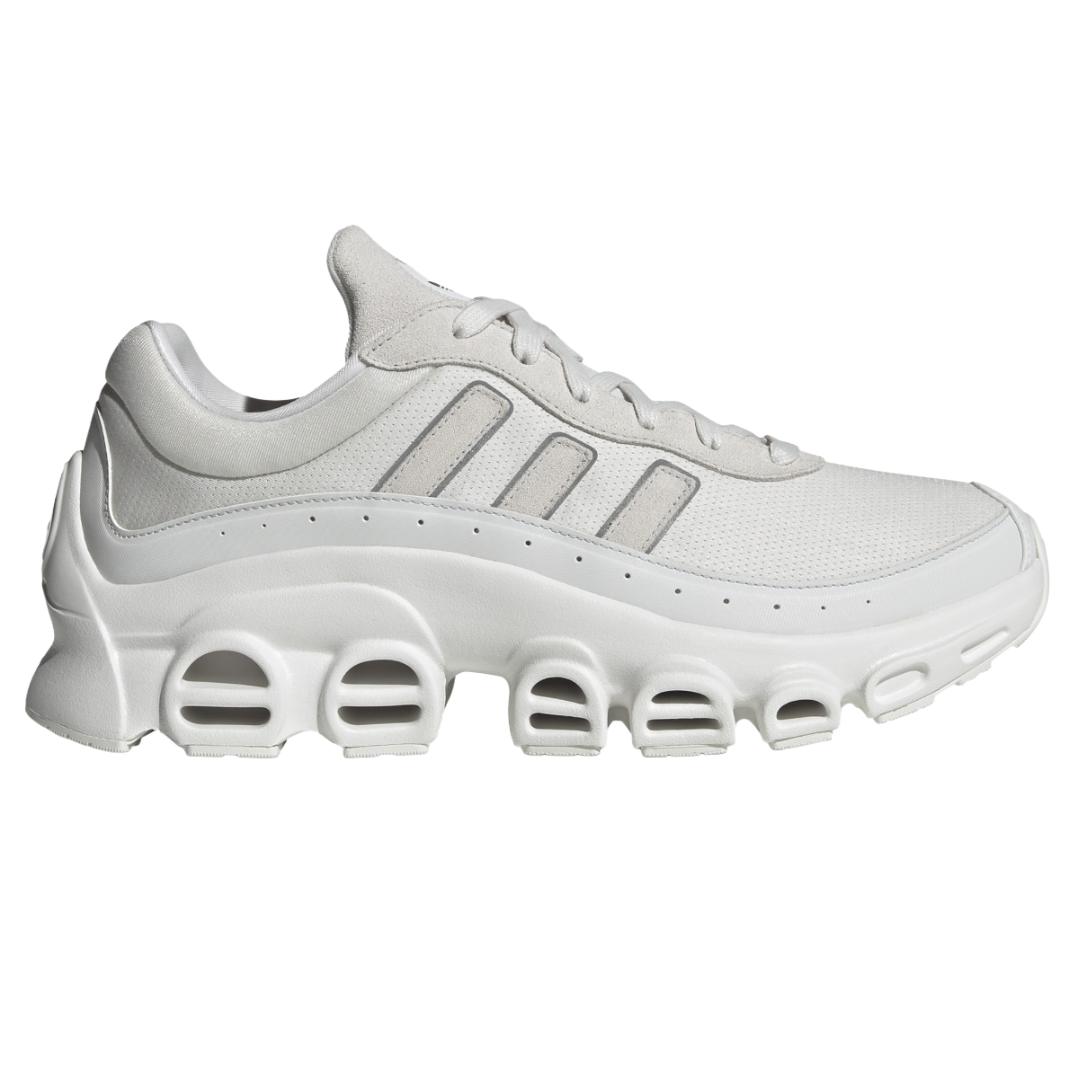 White athletic sneaker with a distinctive, sculpted midsole featuring multiple open-air cutouts and three stripes on the side.