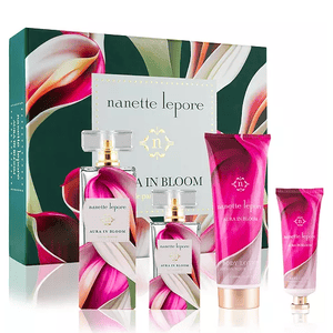 Nanette Lepore Aura in Bloom 4pc Fragrance Set includes a perfume bottle, a mini perfume, a body lotion, and a hand cream, all featuring floral-themed packaging.