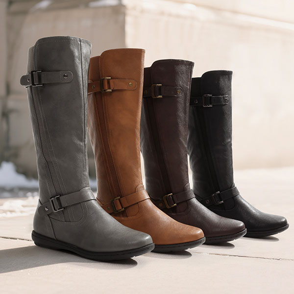 Four pairs of tall, knee-high boots in gray, tan, brown, and black leather, each with buckle detailing near the ankle and calf.