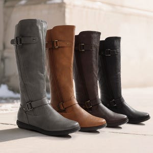 Four pairs of tall, knee-high boots in gray, tan, brown, and black leather, each with buckle detailing near the ankle and calf.