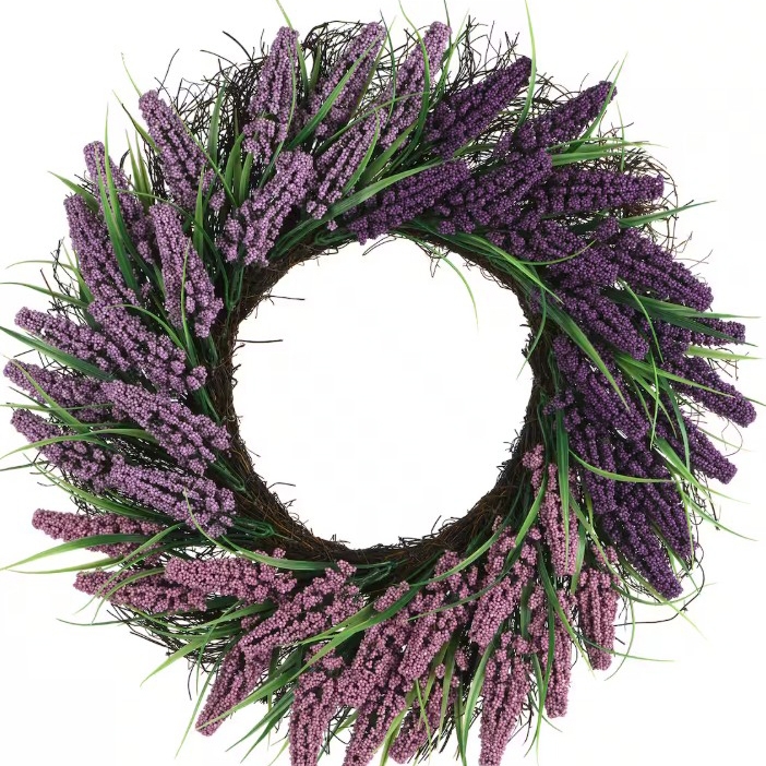 A floral wreath featuring bundles of purple and lavender artificial flowers with green leaves, arranged on a circular brown grapevine base.