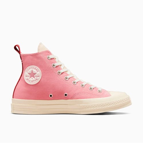 A pink high-top sneaker with white laces and a cream-colored sole.