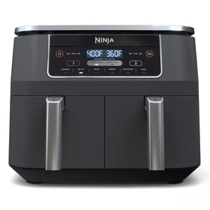 Ninja dual-zone air fryer with two cooking compartments, featuring a digital display and multiple cooking settings including air broil, air fry, roast, reheat, dehydrate, and bake.