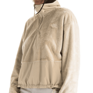 Beige fleece pullover jacket with a high collar, half-zip design, and an adjustable drawstring hem. Upper part is plush texture, lower part features a smooth fabric.