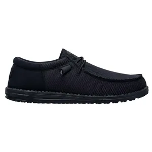 A black slip-on shoe with a textured fabric exterior and a low-profile rubber sole, featuring simple lace detailing.