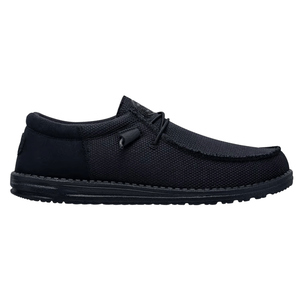 A black slip-on shoe with a textured fabric exterior and a low-profile rubber sole, featuring simple lace detailing.