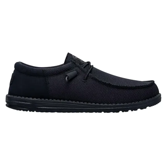 A black slip-on shoe with a textured fabric exterior and a low-profile rubber sole, featuring simple lace detailing.