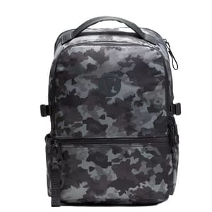 A camouflage-patterned backpack with a top handle, front pocket, and zipper closure, featuring a subtle logo on the front.