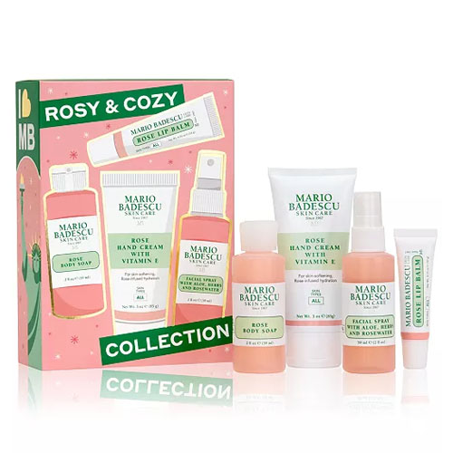 The Mario Badescu Rosy & Cozy Collection includes Rose Body Soap, Rose Hand Cream with Vitamin E, Aloe Facial Spray, and Rose Lip Balm, showcased in a pink box with a holiday theme.