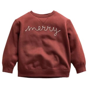A red-brown sweatshirt featuring the word \“merry\“ in festive script across the chest.