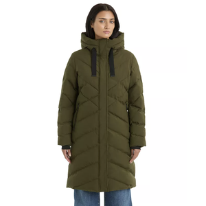 A woman is wearing an olive green, long puffer coat with a hood and black drawstrings, paired with blue jeans.