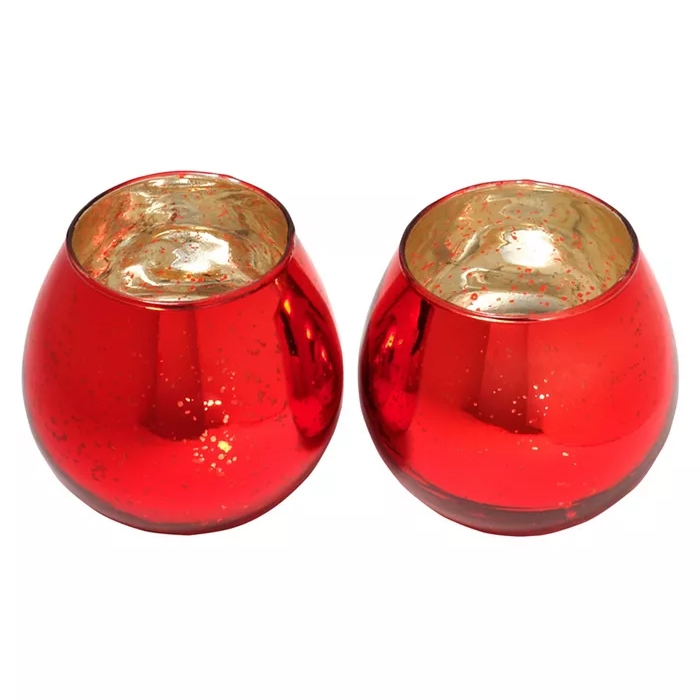 Set of two round red glass votive holders with a reflective gold interior, designed to create a warm and inviting glow when candles are lit.