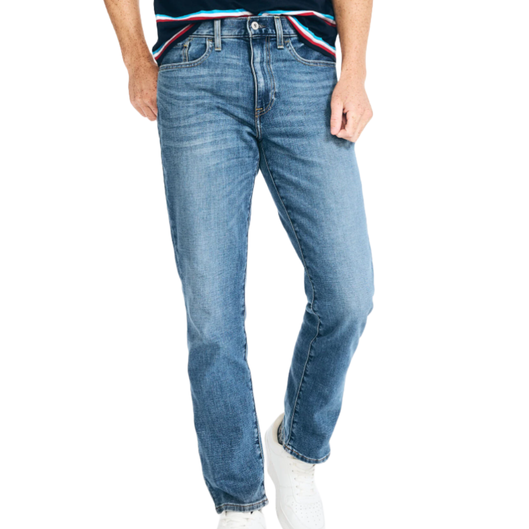Nautica jeans in a classic blue wash feature a straight-leg fit, with five pockets and a button closure, paired with white sneakers.