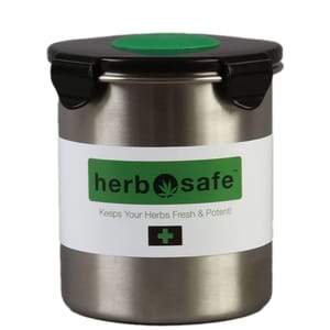 Stainless steel herb container with a black lid, featuring the brand \“herbsafe\“ and a green leaf logo. It is designed to keep herbs fresh and potent.