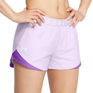 A person is wearing light purple Under Armour athletic shorts with a darker purple trim.