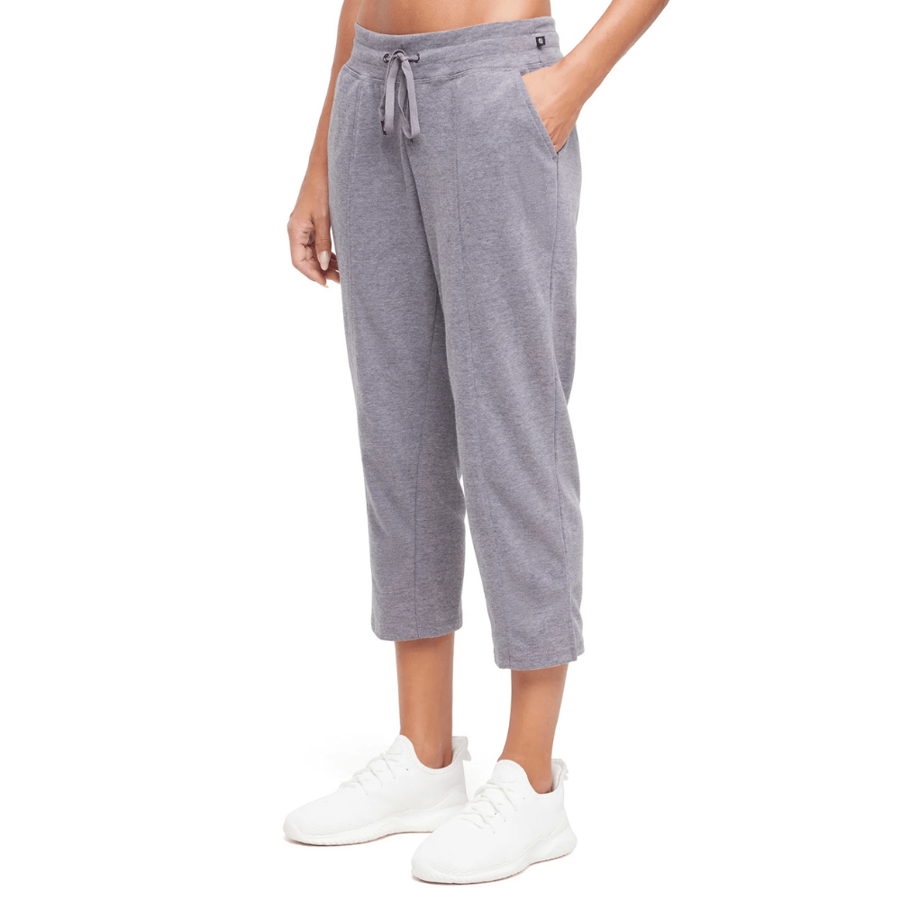 Gray cropped sweatpants with a drawstring waist and side pockets, paired with white sneakers.