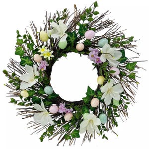 Spring wreath made of twigs, adorned with white flowers, green leaves, and pastel-colored decorative eggs.