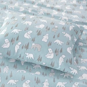 Bedding set with polar bear and pine tree print on a light blue background.