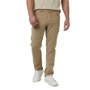 Beige slim-fit sweatpants with a jeans-style design, featuring front and back pockets, belt loops, and button closure, paired with white sneakers.