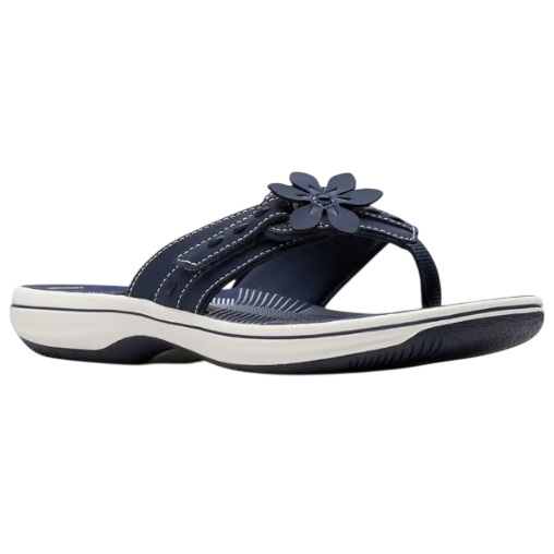 A navy blue thong sandal featuring a floral embellishment, white stitching, and a cushioned, contoured sole for comfort.