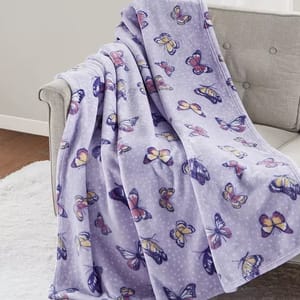 A purple blanket with a butterfly pattern draped over a chair.