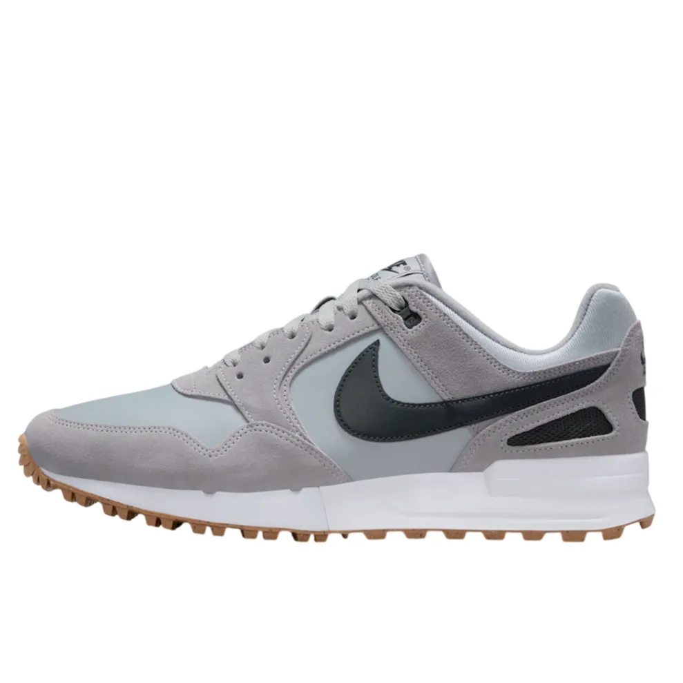 A light grey sneaker with a black swoosh, featuring suede overlays and a gum sole.