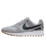 A light grey sneaker with a black swoosh, featuring suede overlays and a gum sole.