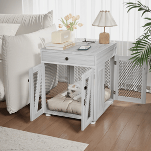 A dual-purpose end table doubles as a dog crate with mesh doors, housing a dog on a cushion. The top surface holds a lamp, books, a speaker, and a phone.