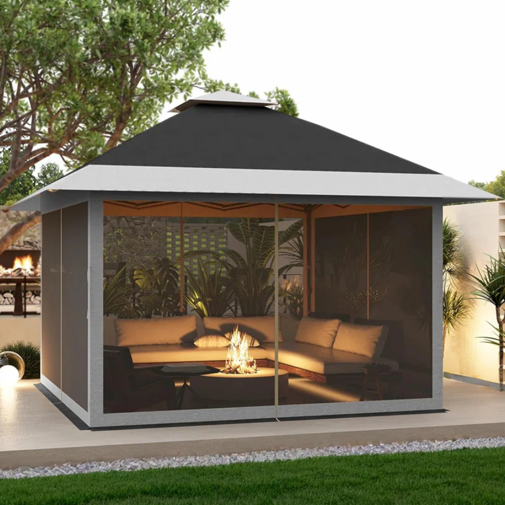 A gazebo with a gray and black roof encloses a cozy seating area with plush cushions around a small fire pit.