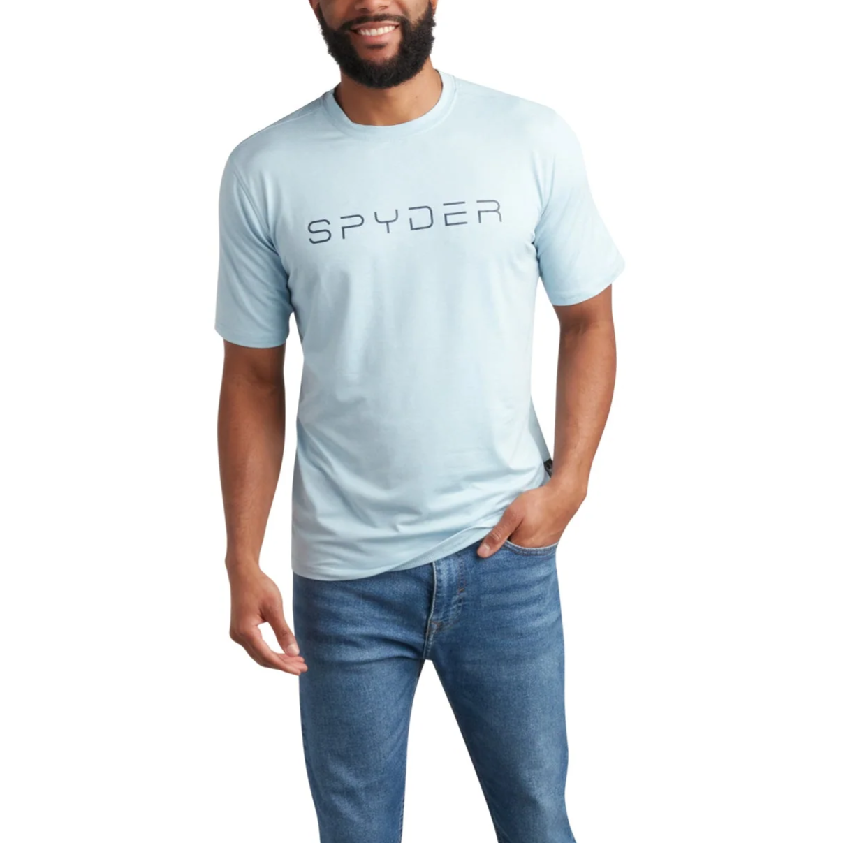 A man is wearing a light blue \“SPYDER\“ T-shirt, blue jeans, and white sneakers.