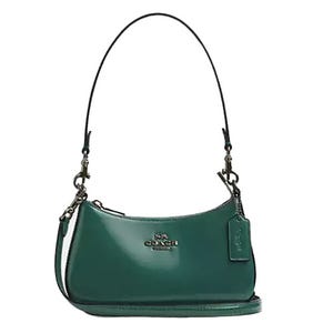 A green leather Coach Outlet shoulder bag with a short strap, featuring a minimalist design with a zippered top and Coach logo on the front.