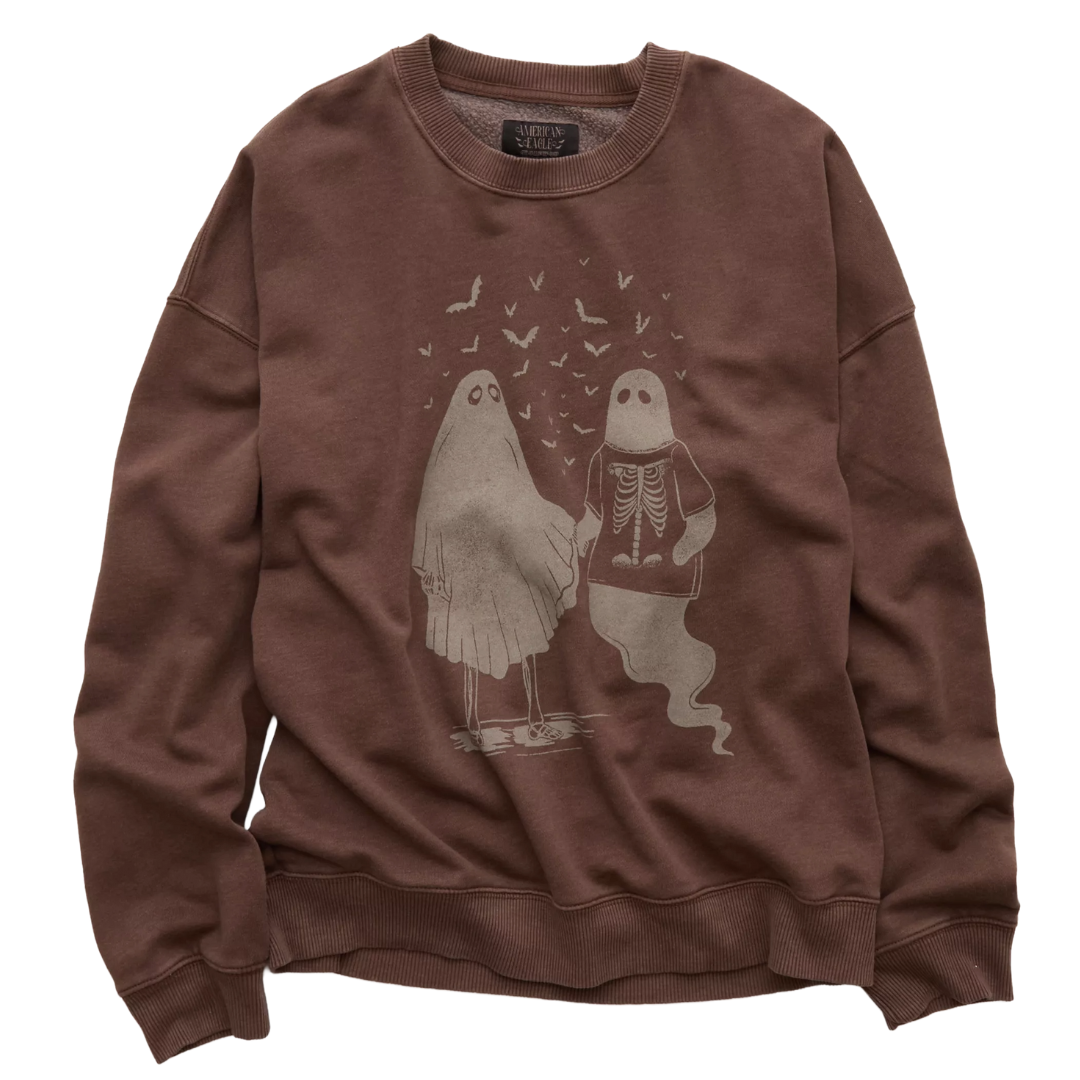 Brown sweatshirt with a design of two cartoon ghosts holding hands, one in a sheet and the other with a visible skeleton, surrounded by flying bats.