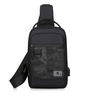 Black crossbody pack with a USB port, features front zipper pockets, camouflage pattern, and adjustable strap.