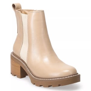 Beige Chelsea boot with a chunky heel, pull tab, and elastic side panels for easy slip-on. Features a lug sole for added traction.