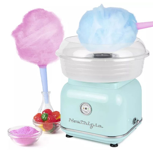 A cotton candy machine with two sticks of blue and pink cotton candy and a bowl of colorful candies beside it.