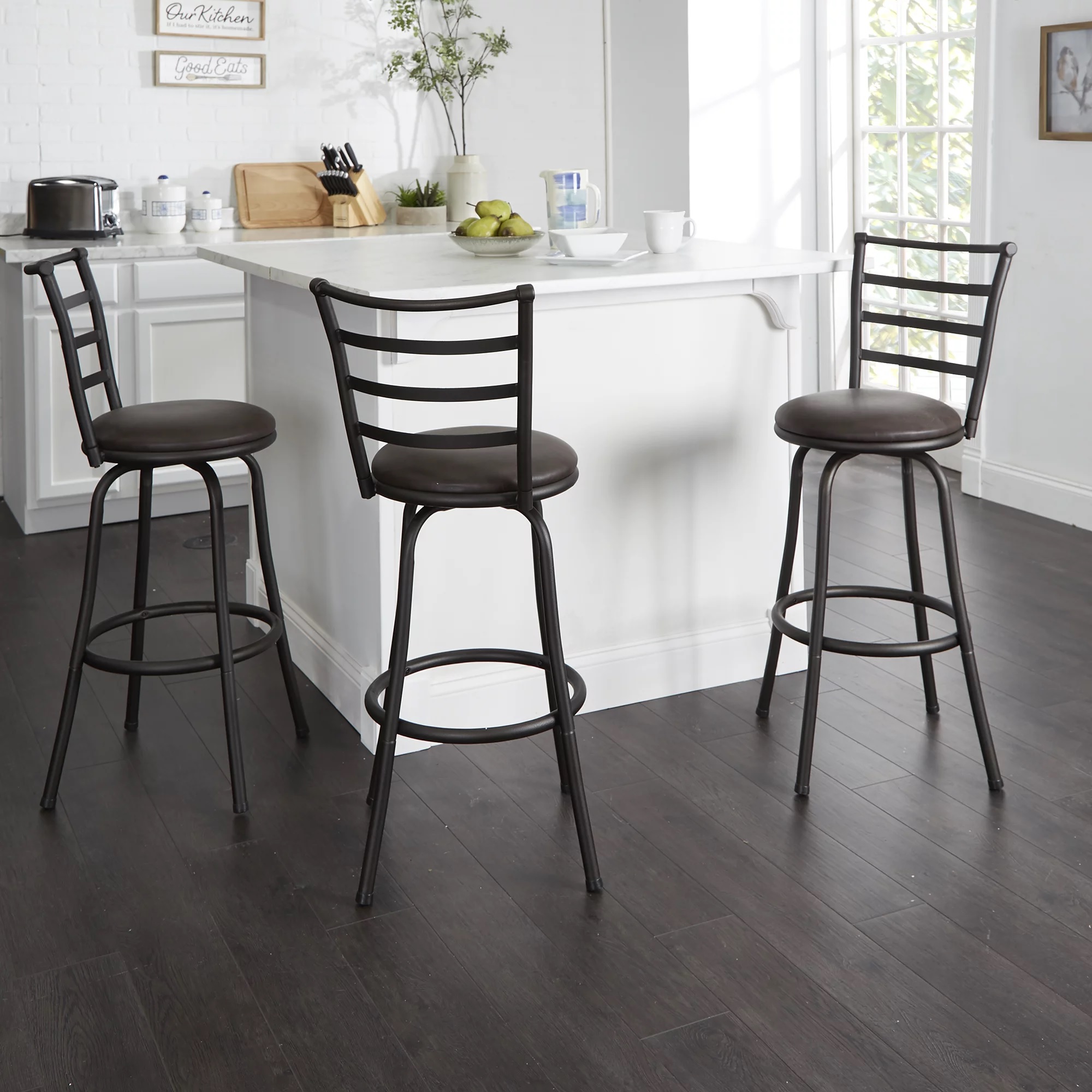 Two brown bar stools with metal frames beside a kitchen island.